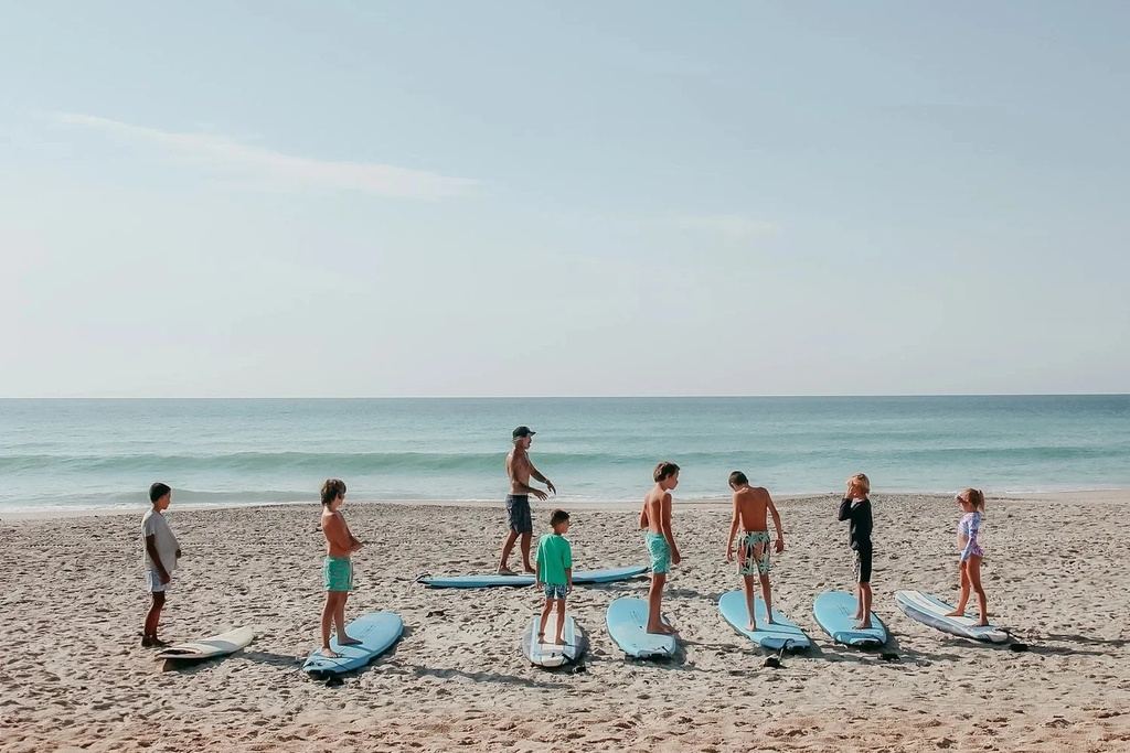 Kids' surf lesson on the beach near Seaside Sanctuary